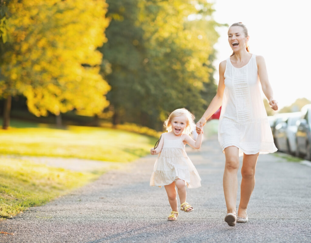 Happy mother and child walking hand-in-hand. 